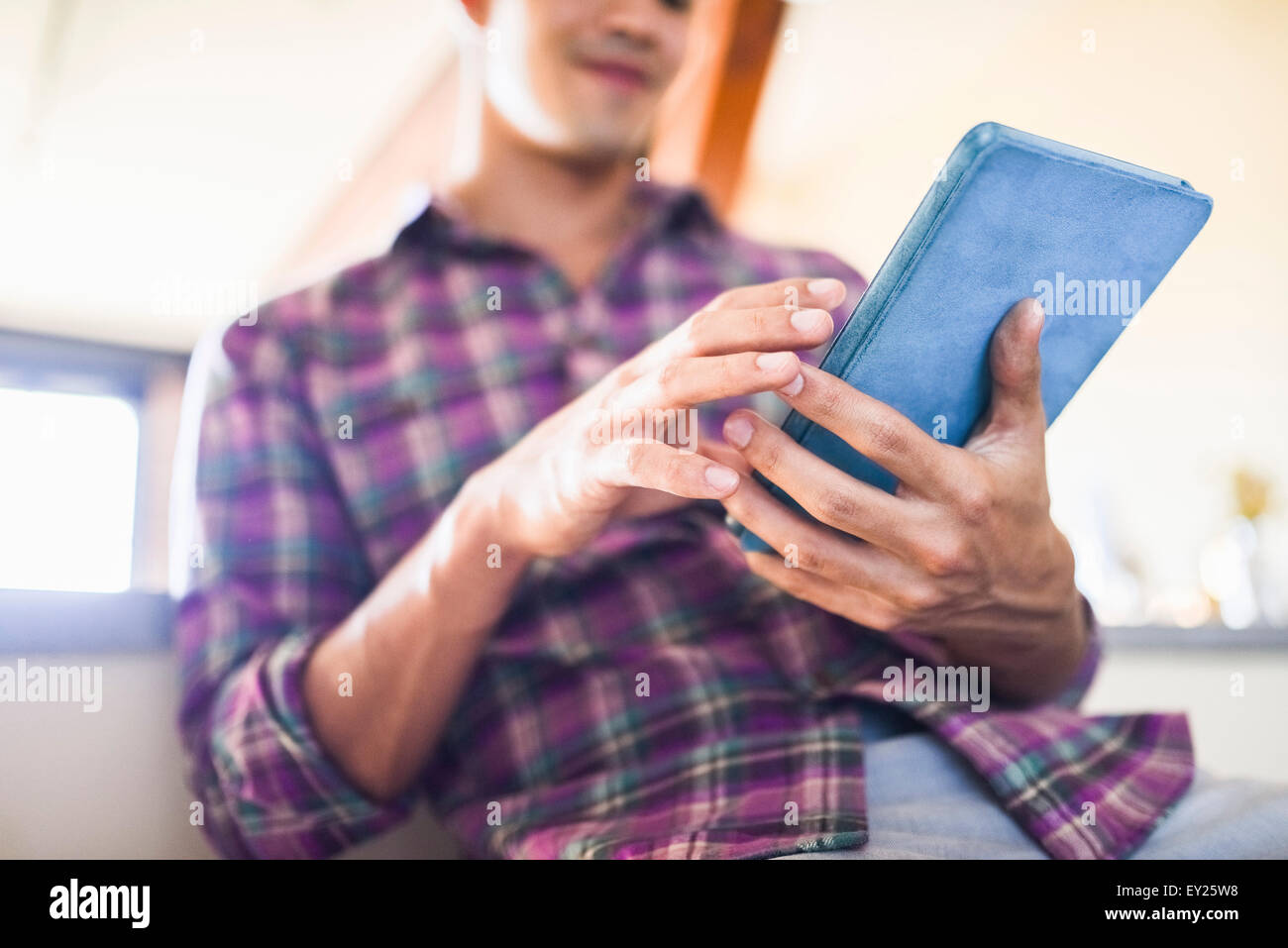 Young Man Using Tablet Young man using digital tablet Stock Photo - Alamy