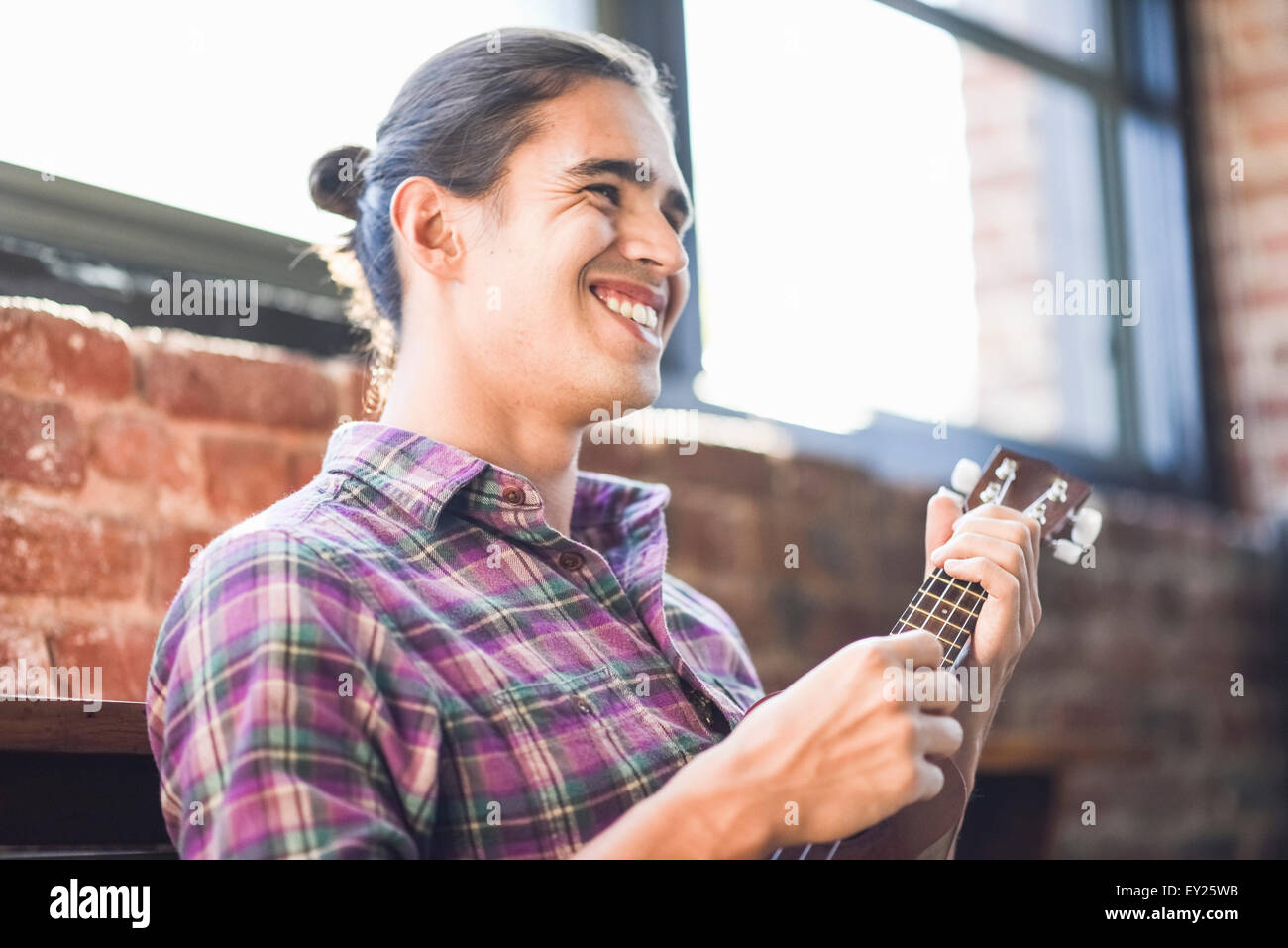 Young man playing ukulele Stock Photo