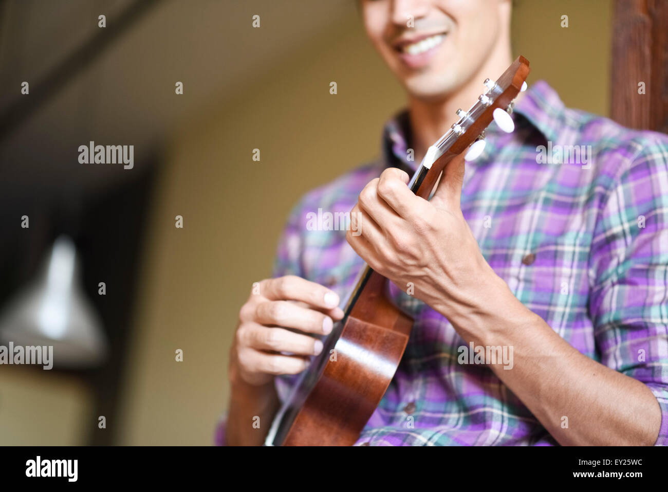 Young man playing ukulele Stock Photo