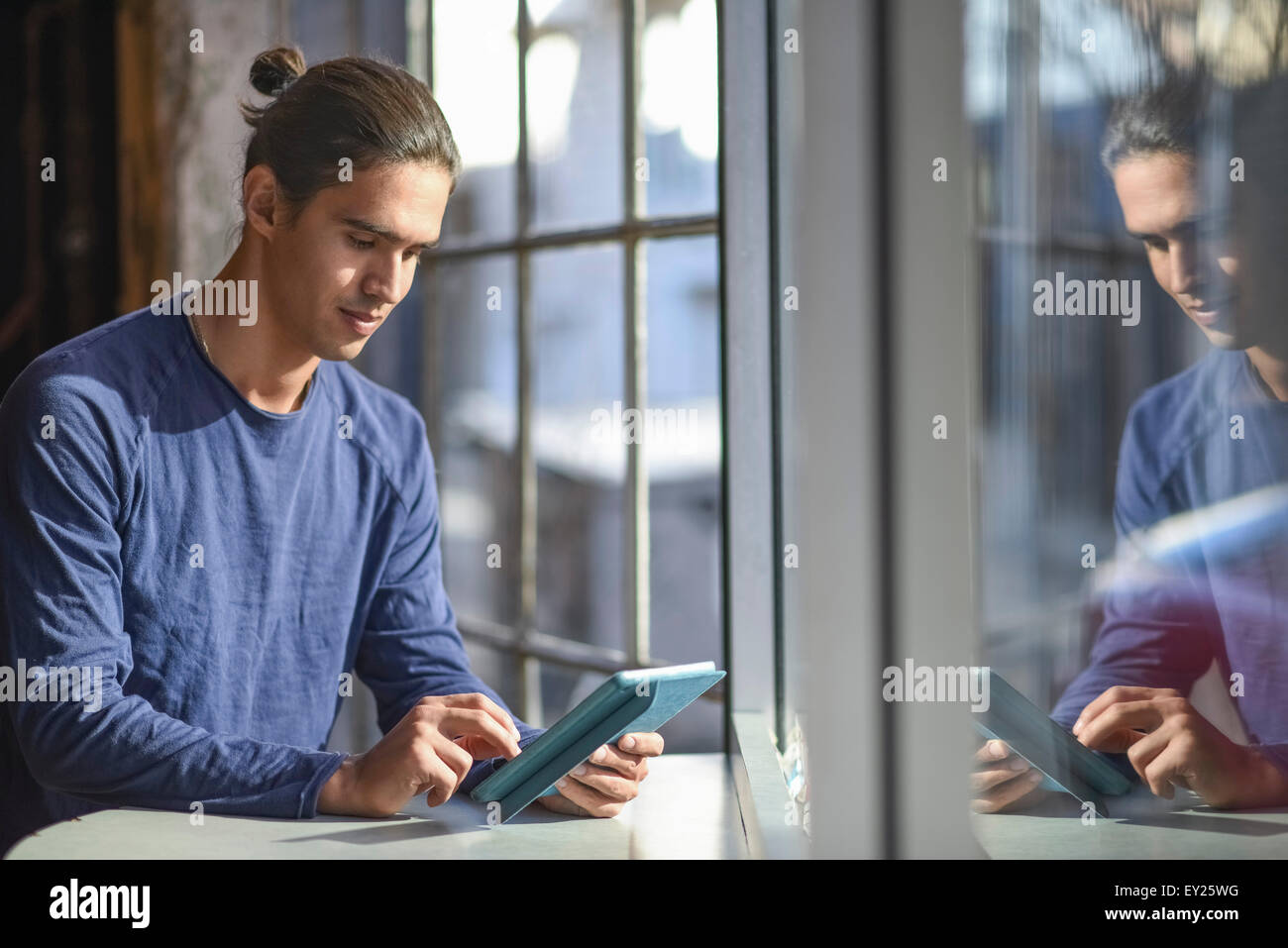 Young Man Using Tablet Young man using digital tablet Stock Photo - Alamy