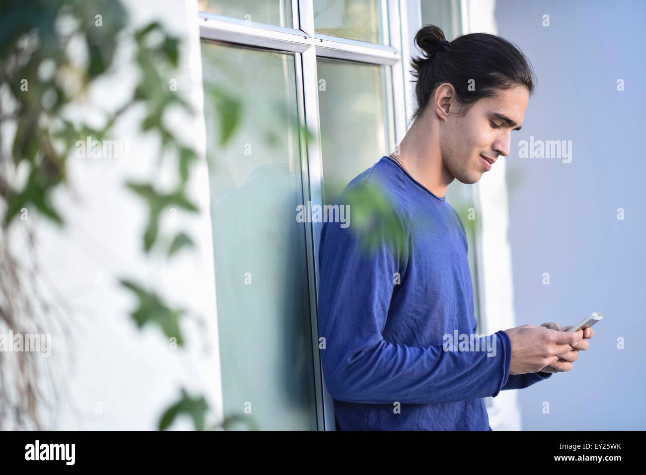 Young man using mobile phone Stock Photo