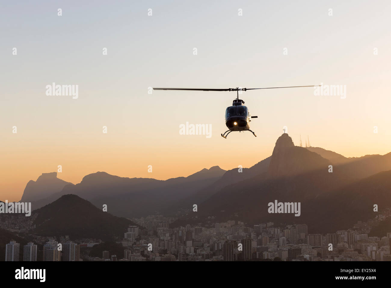 Silhouetted view of helicopter and Christ the Redeemer at dawn, Rio De Janeiro, Brazil Stock Photo
