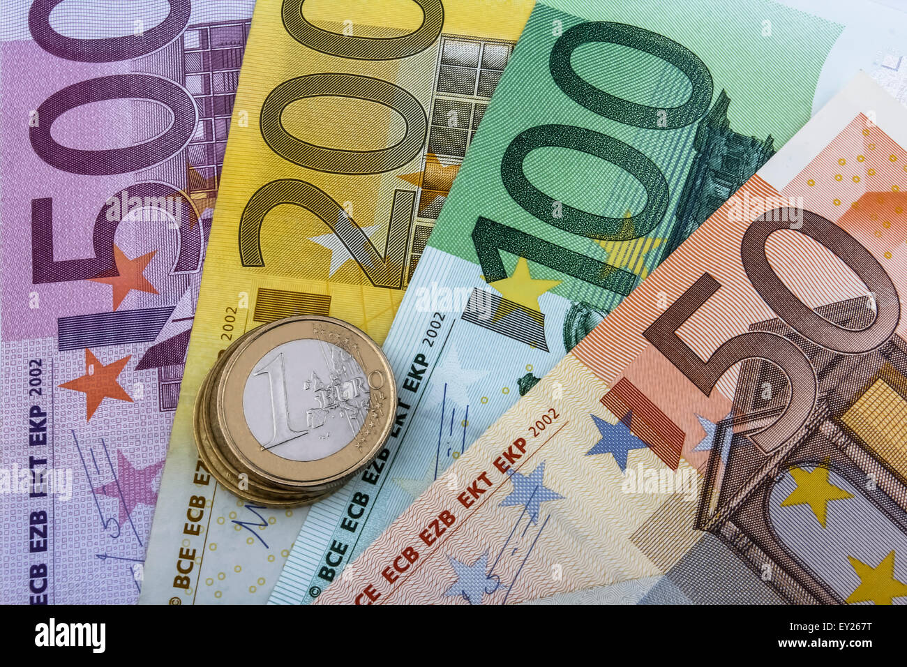 Euros (EUR) coins and notes. 50, 100, 200 and 500 Euro note with a few Euro coins on top. Stock Photo