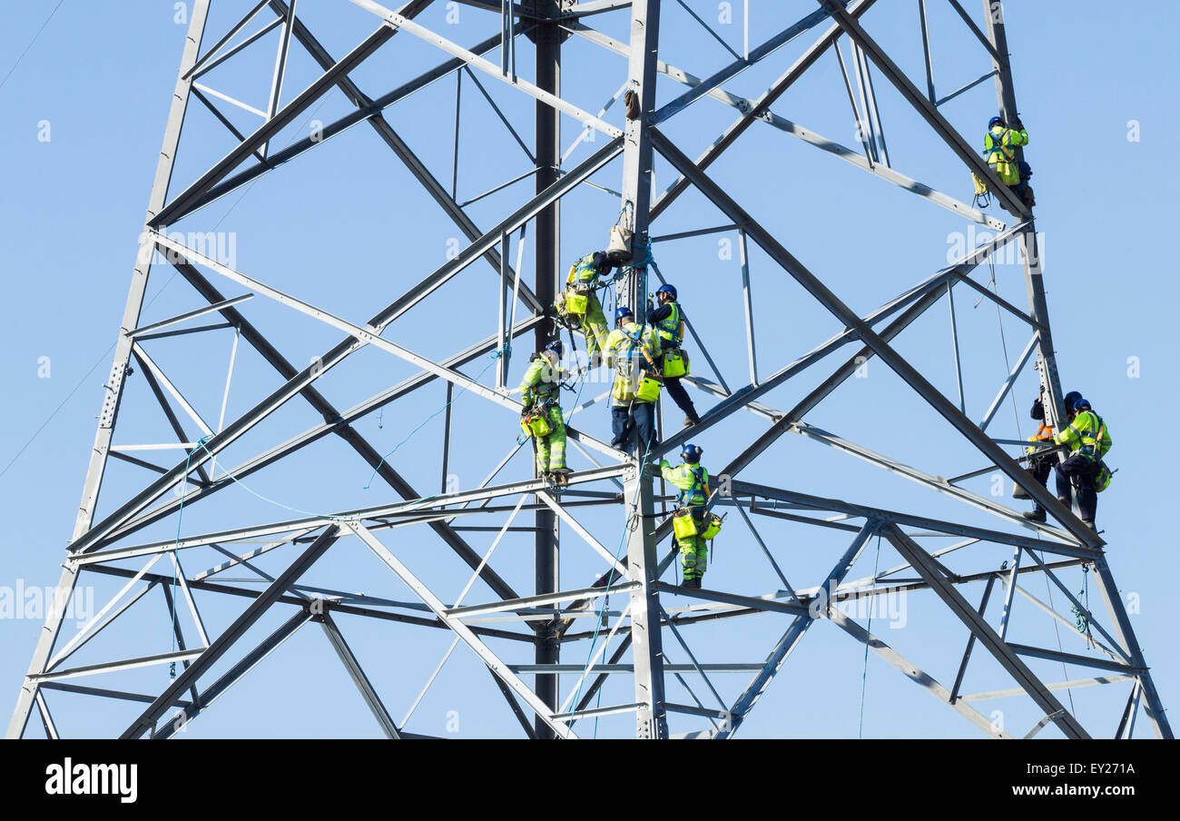 Workers erecting 145 metre tall electricity pylons across the river Tees near Middlesbrough, north east England, United Kingdon Stock Photo