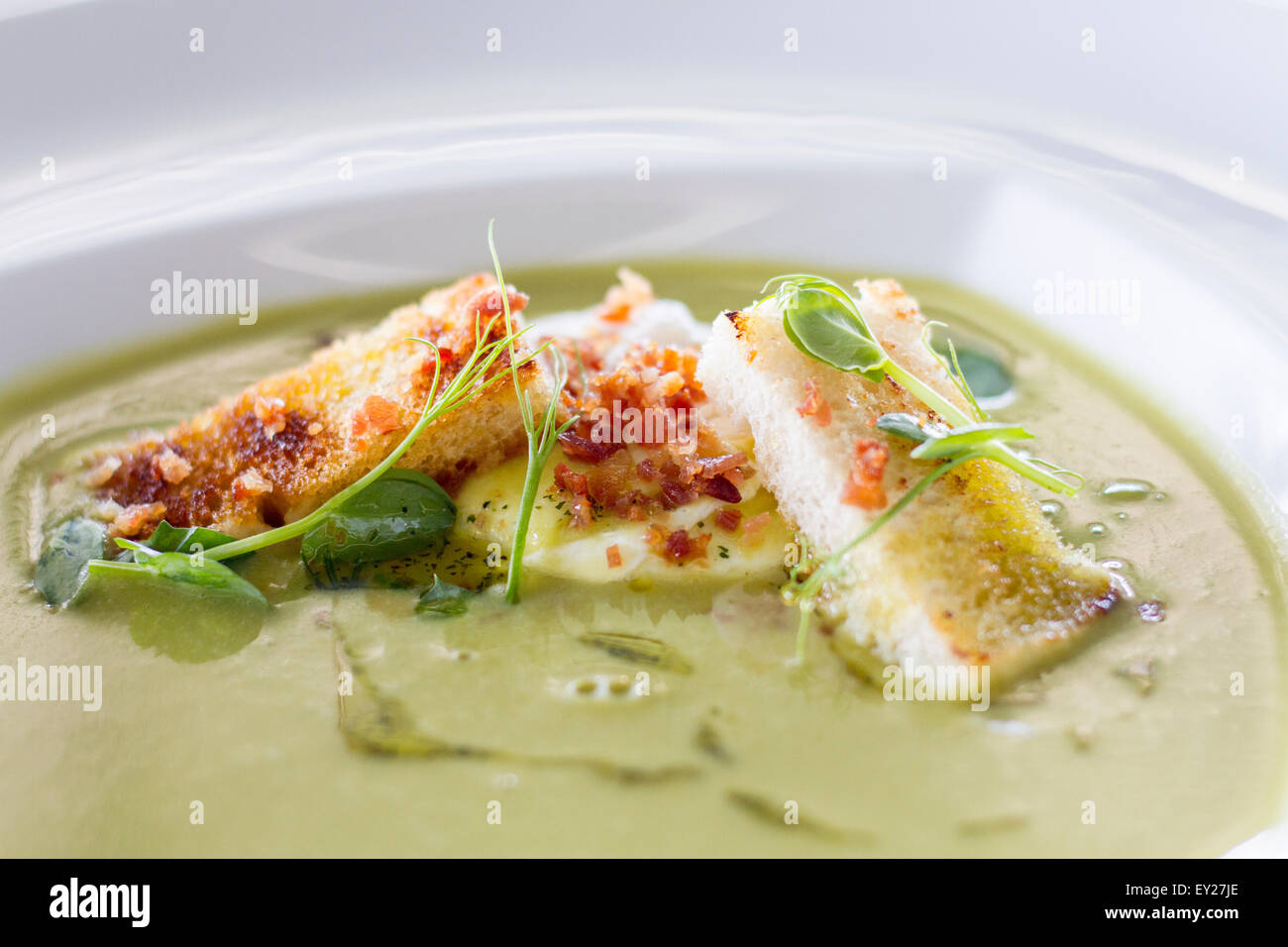 Pea cream with egg and bacon Stock Photo