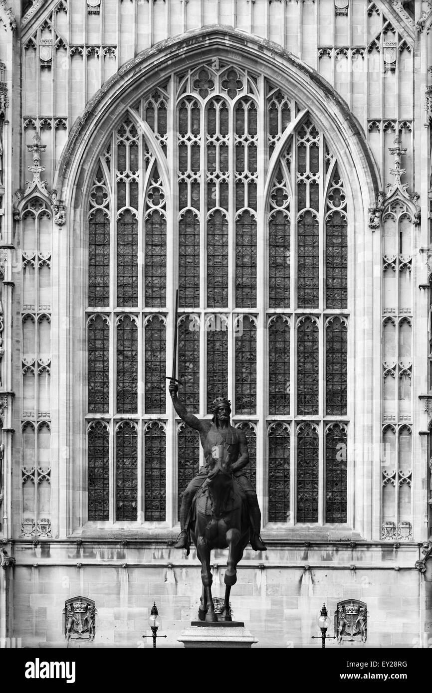 A large window on The Houses of Parliament, Westminster, London, England with a statue of Richard The Lionheart in front Stock Photo