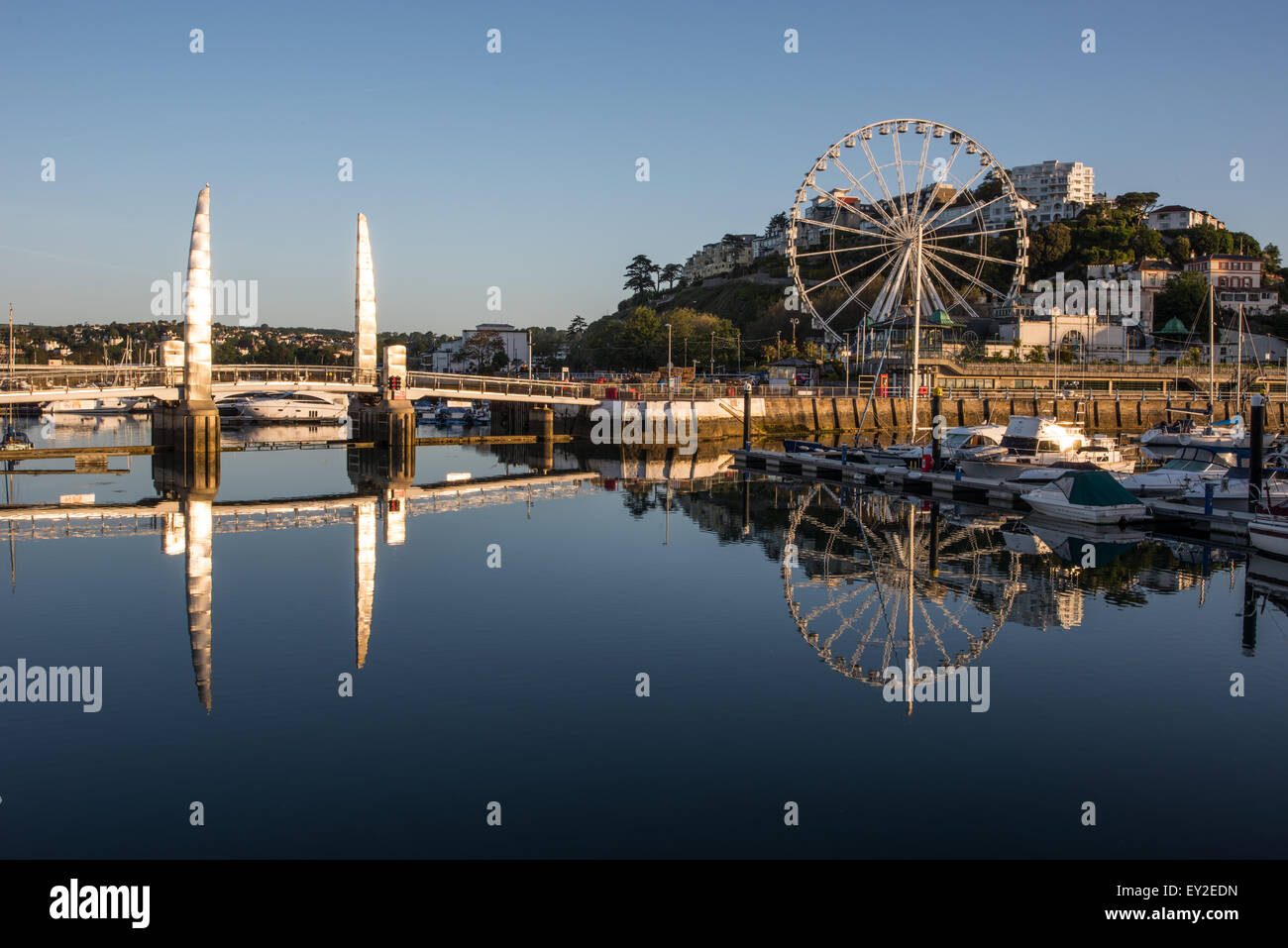 Torquay Harbour at Sunrise with boats a jetty a bridge and ferris wheel June 2015 Devon uk Stock Photo