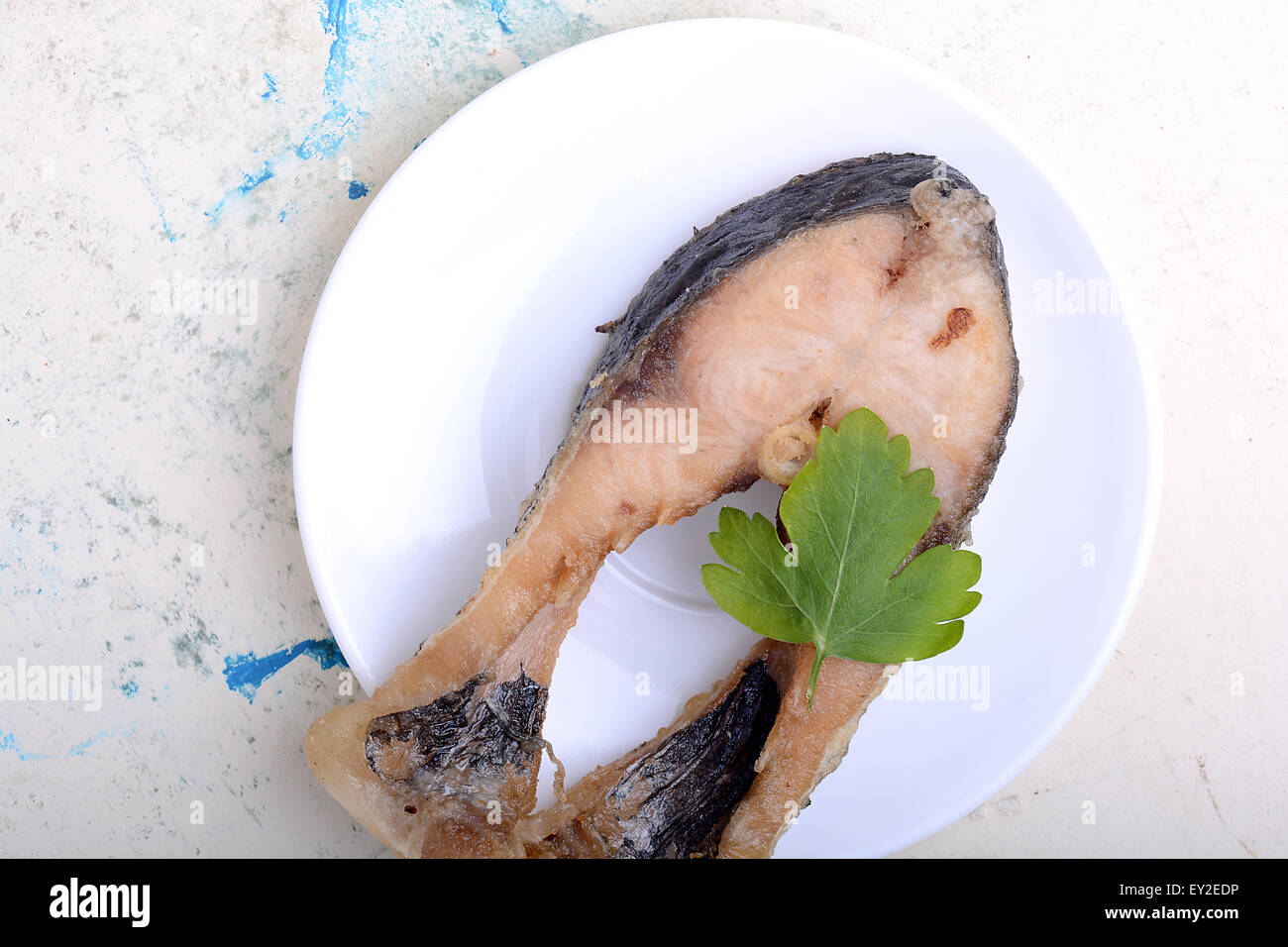 Frying pan with one roasted salmon steaks, view from above Stock Photo