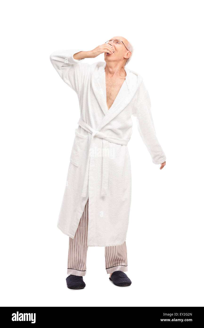 Full length portrait of a sleepy senior man in a white bathrobe yawning  isolated on white background Stock Photo - Alamy