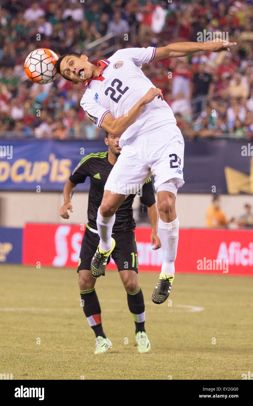 July 19, 2015: Costa Rica midfielder Jose Miguel Cubero (22) heads the ball with Mexico forward Carlos Vela (11) behind him during the CONCACAF Gold Cup 2015 Quarterfinal match between the Costa Rica and Mexico at MetLife Stadium in East Rutherford, New Jersey. Mexico won 1-0. (Christopher Szagola/Cal Sport Media) Stock Photo