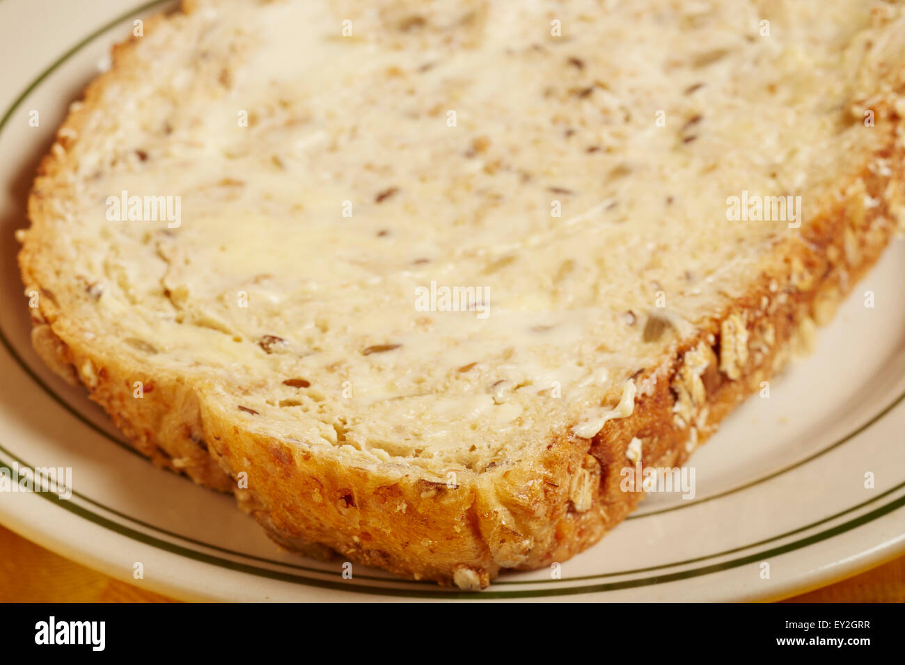 a slice of buttered multigrain bread Stock Photo