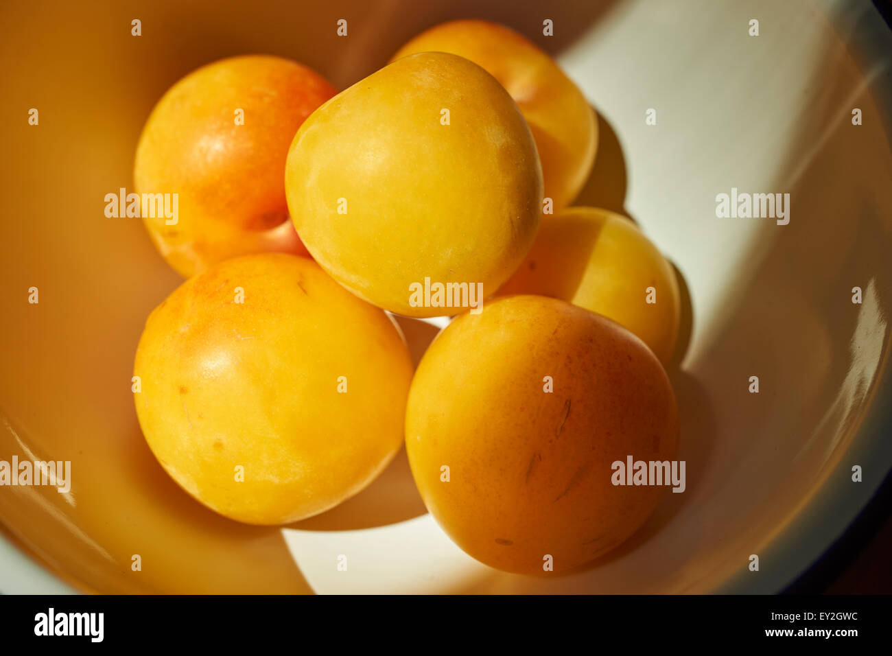 A bowl of yellow plums Stock Photo