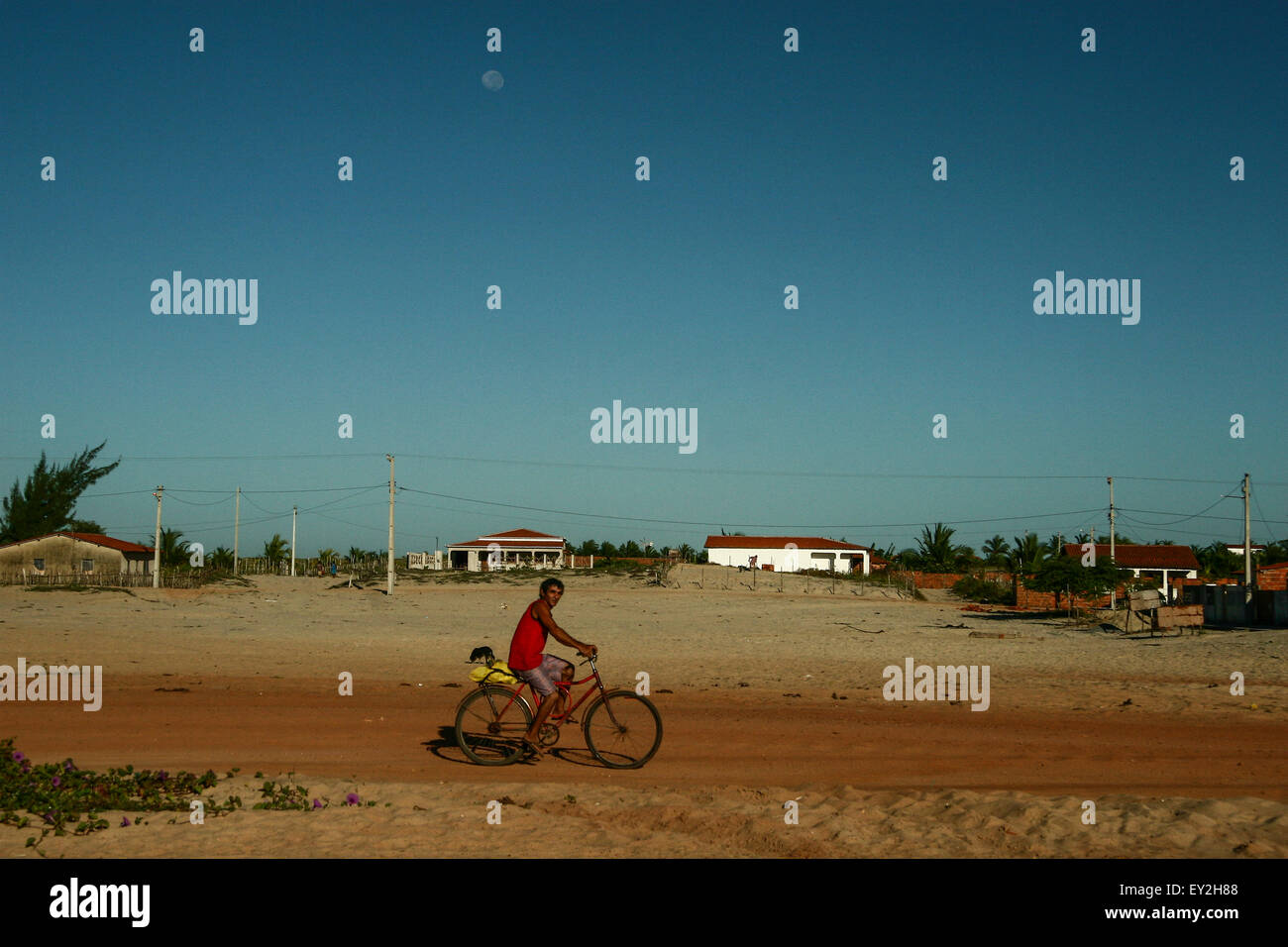 Fisherman riding a bicycle to work in Preá village, Jericoacoara, Ceará