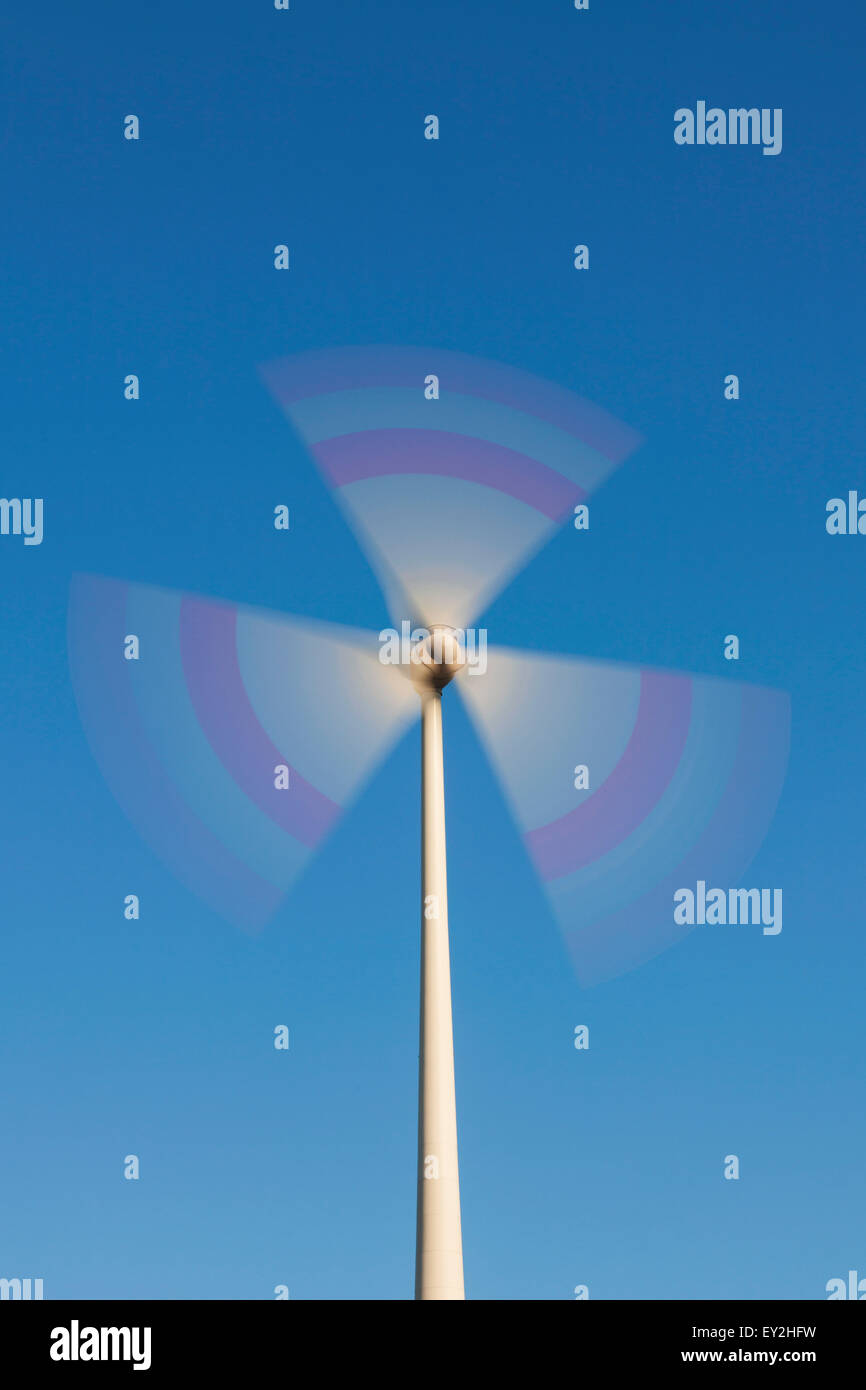 Spinning rotor blades of wind turbine against blue sky Stock Photo Alamy