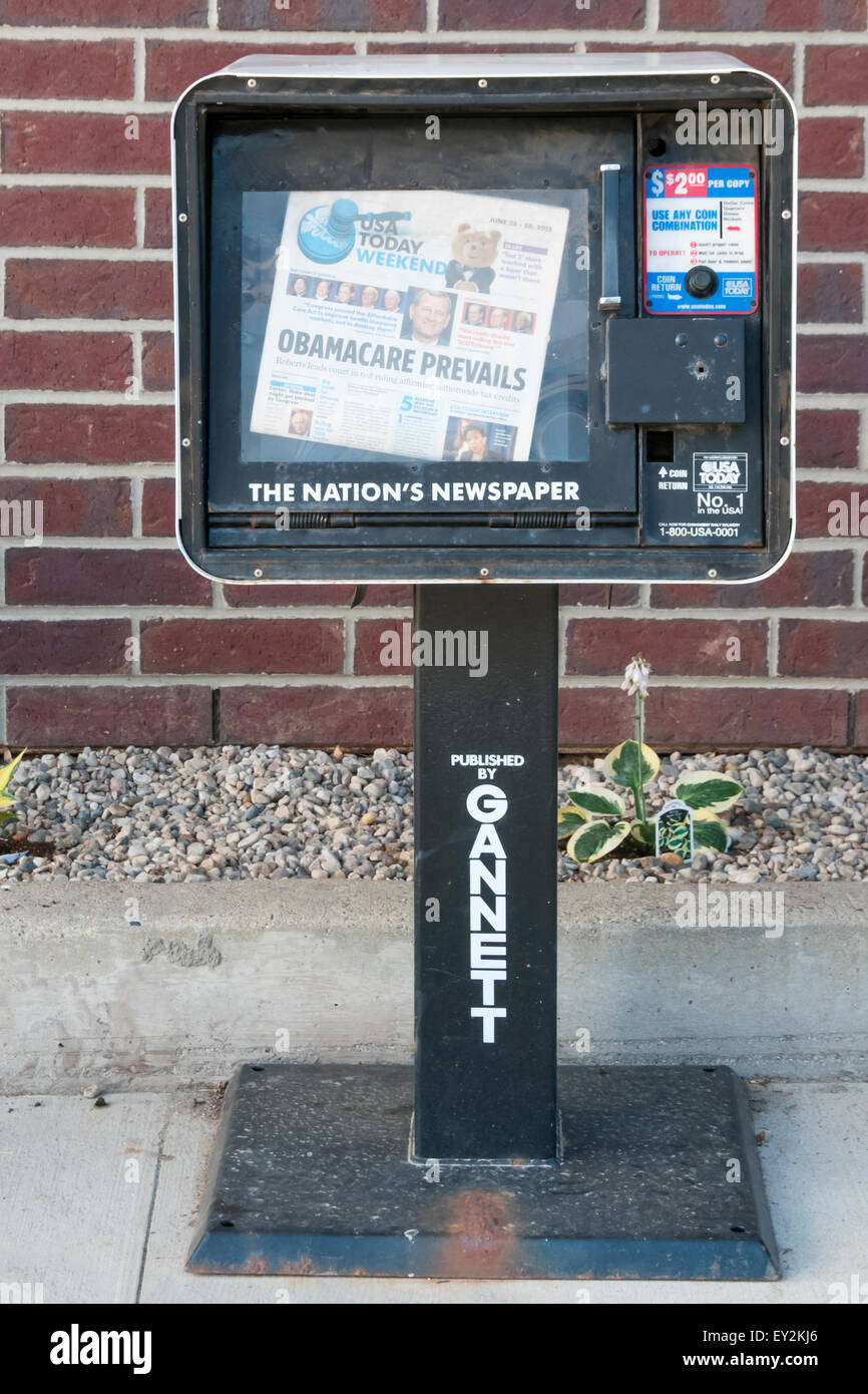 A copy of USA Today in a vending machine, with the headline Obamacare Prevails. Stock Photo