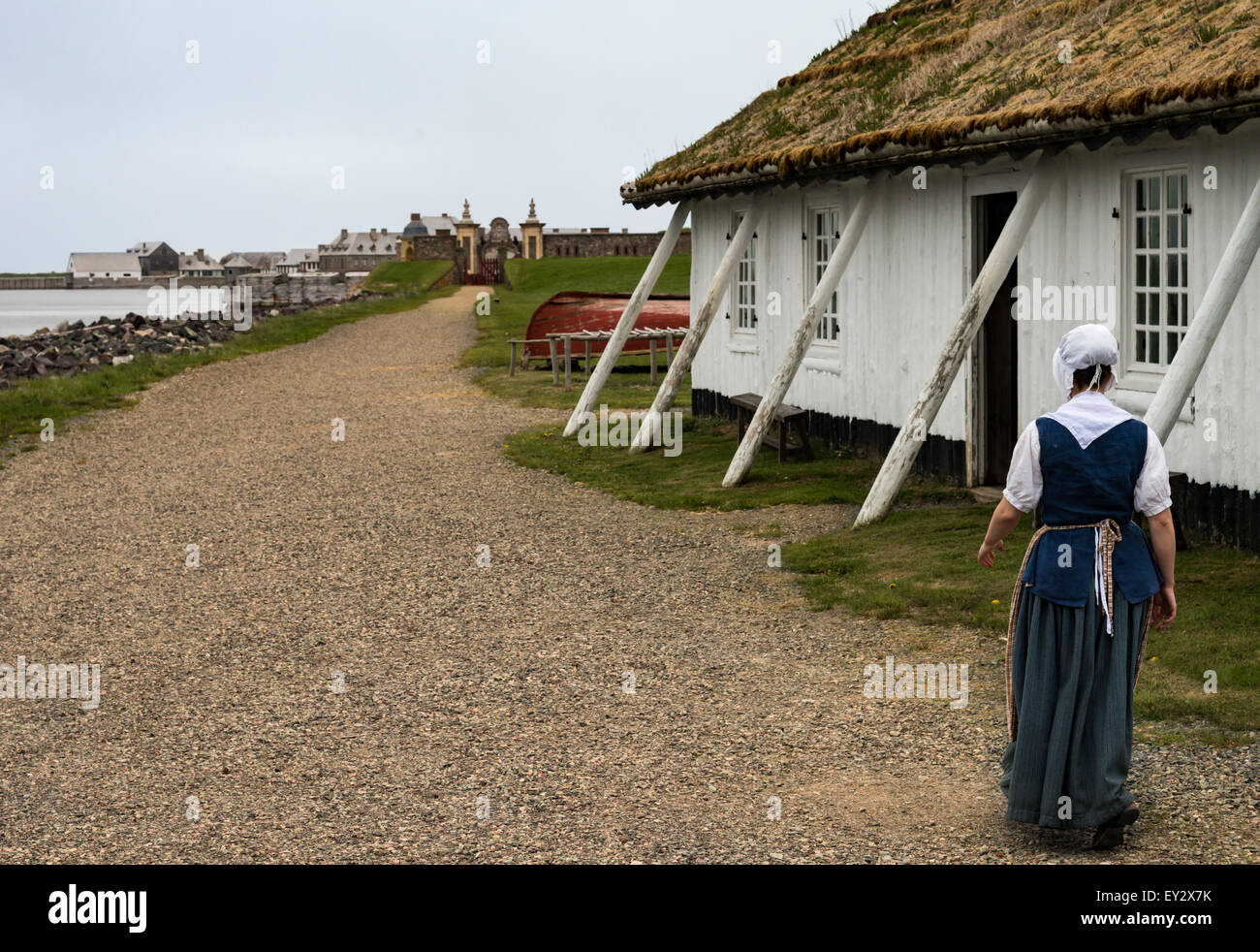 Woman in period costume at Des Roches house at Fortress Louisbourg, Louisbourg, Nova Scotia, Canada - Stock Image