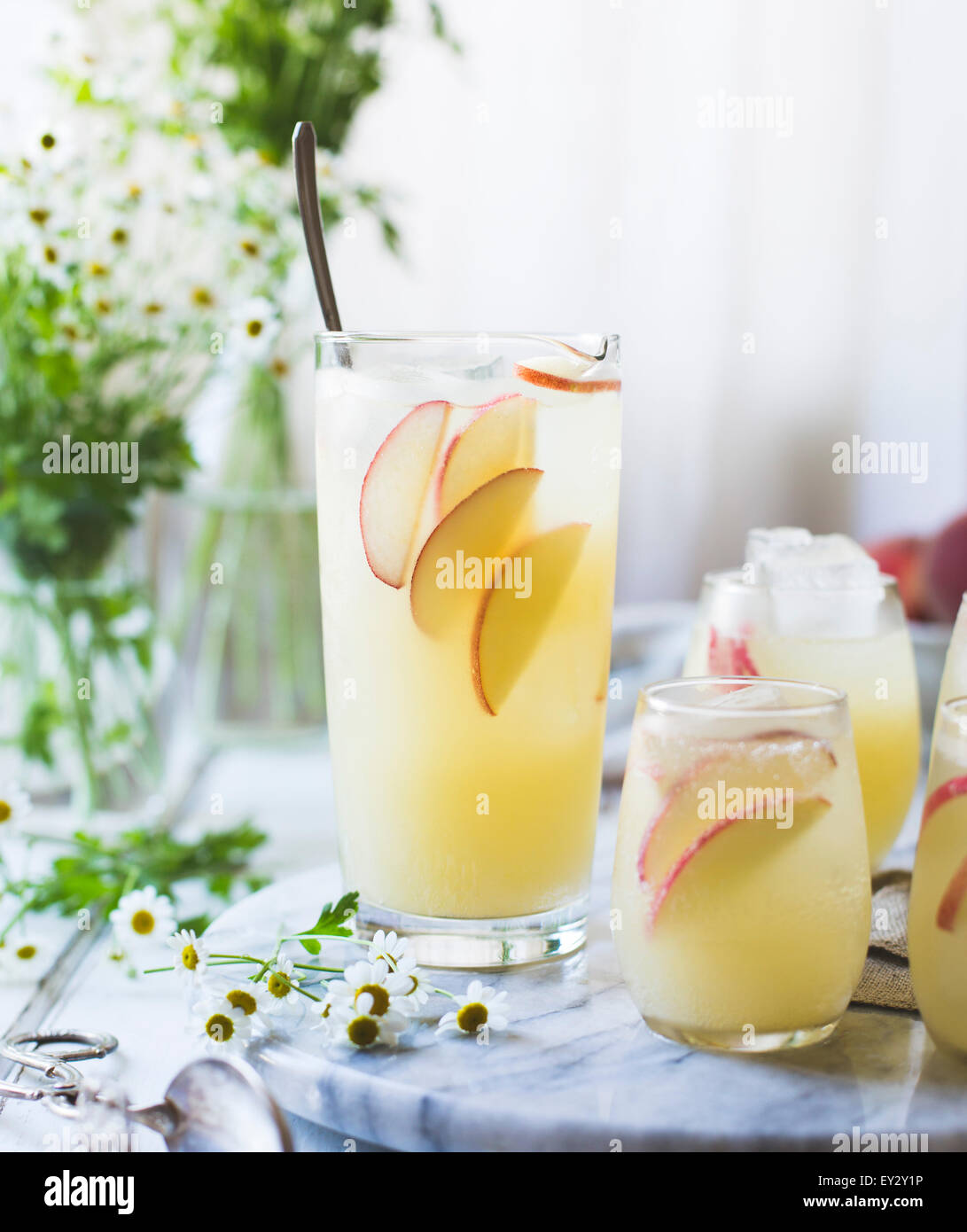 White Nectarine Prosecco Sangría with Ginger & Elderflower in a glass Stock Photo