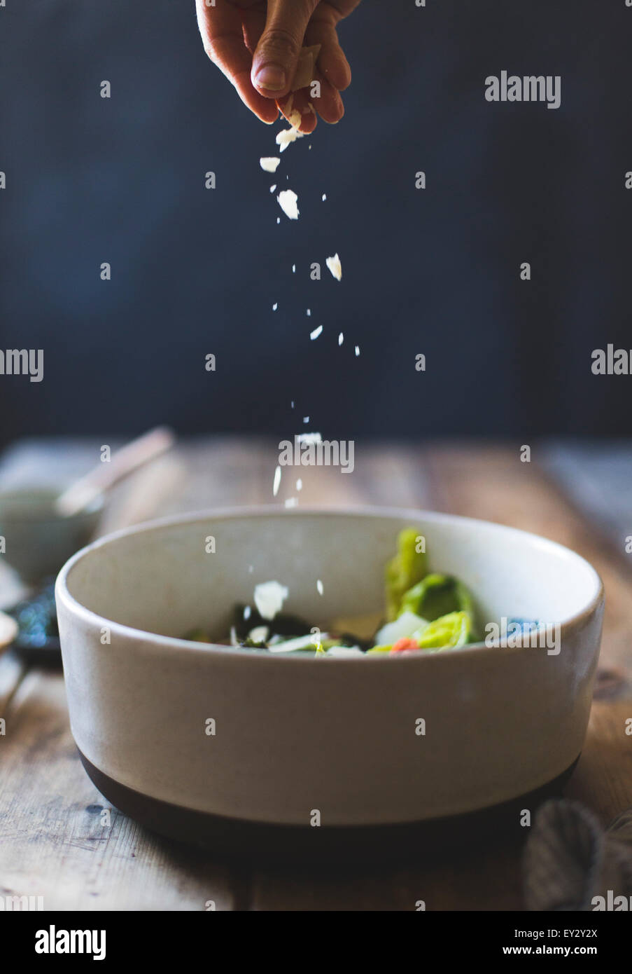 Ingredients for Wasabi Caesar Salad (gluten-free). Sprinkling parmesan cheese. Stock Photo