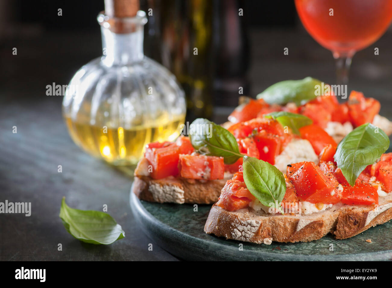 Italian tomato bruschetta with basil and olive oil on crusty slice of bread Stock Photo