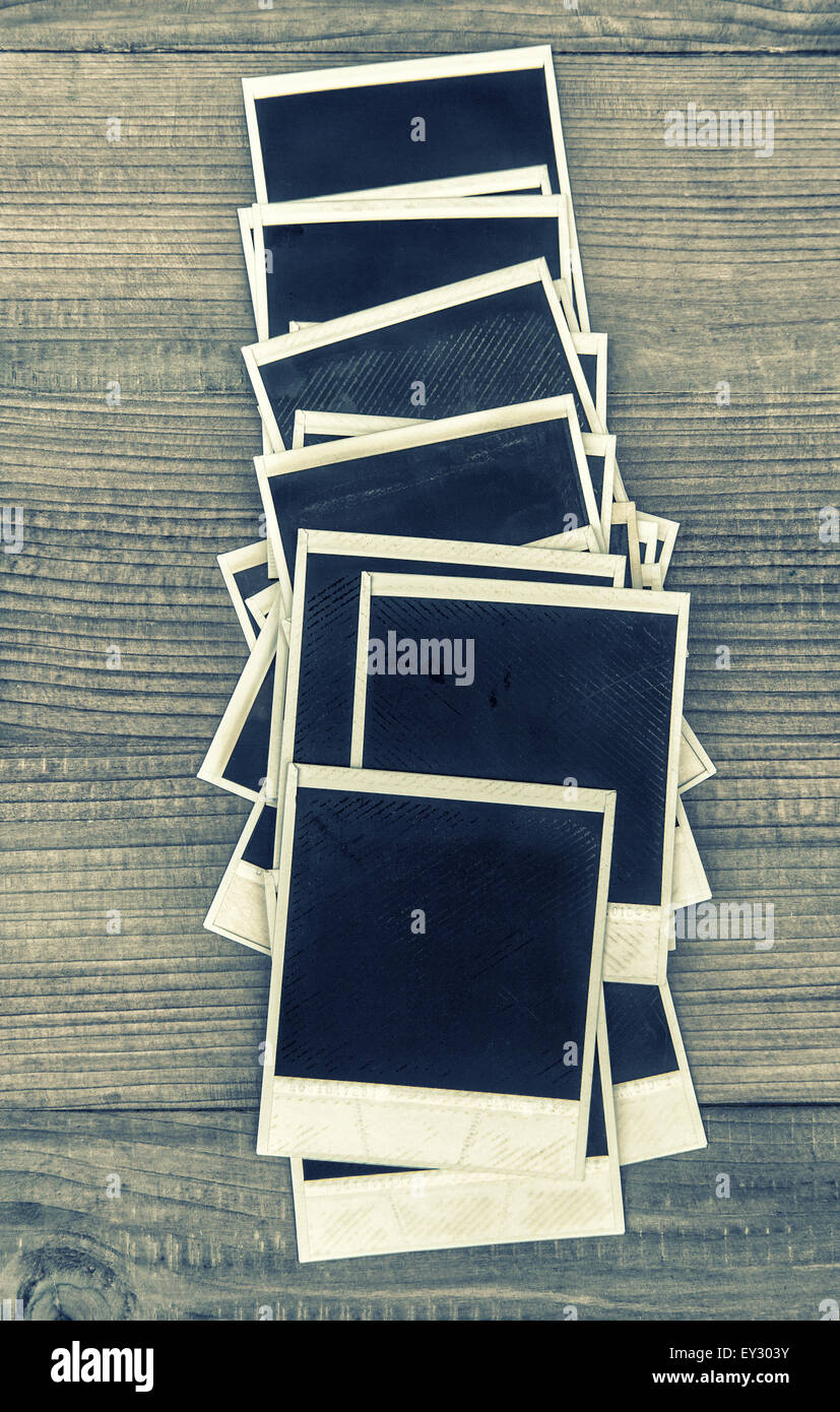 Retro style instant photo frames on rustic wooden background. Vintage toned  picture Stock Photo - Alamy