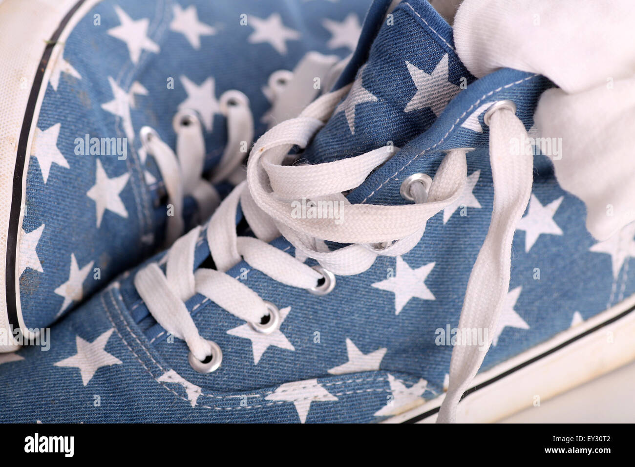 Fancy blue fake converse shoes or trainers with stars on them Stock Photo