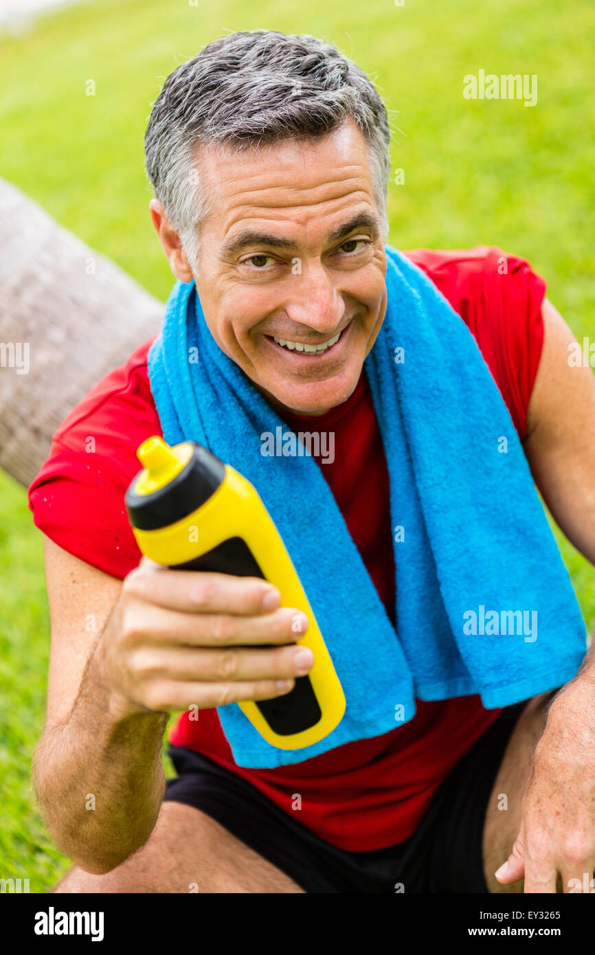 Portrait of a senior man holing a water bottle, hydrating after his workout Stock Photo