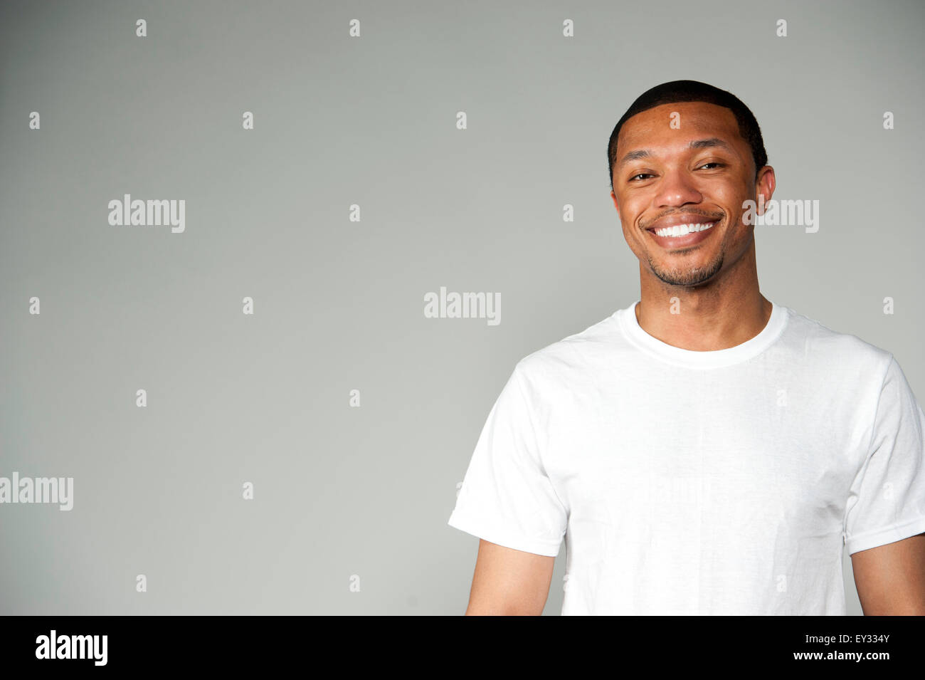 Happy black man white shirt hi-res stock photography and images - Alamy