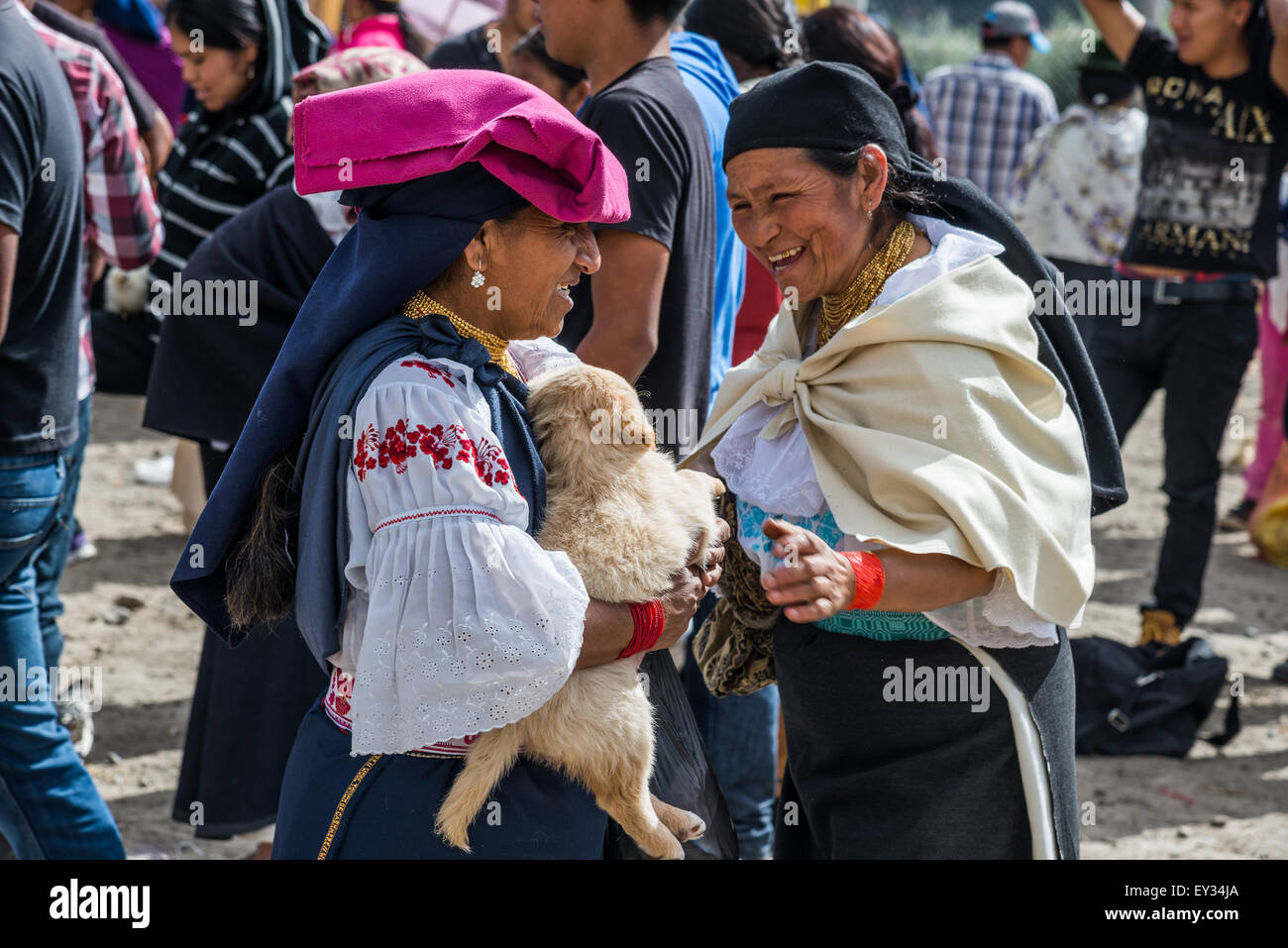 Two native woman having a nice chat at local market. Otavalo, Ecuador. Stock Photo