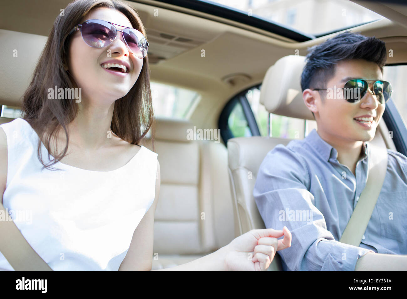 Happy young couple in a car Stock Photo - Alamy