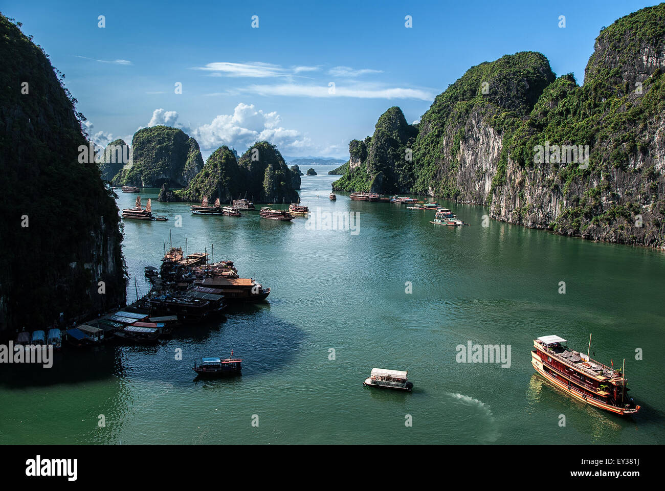 Halong Bay from above with some boats, clouds and karst formations composing the image. Stock Photo