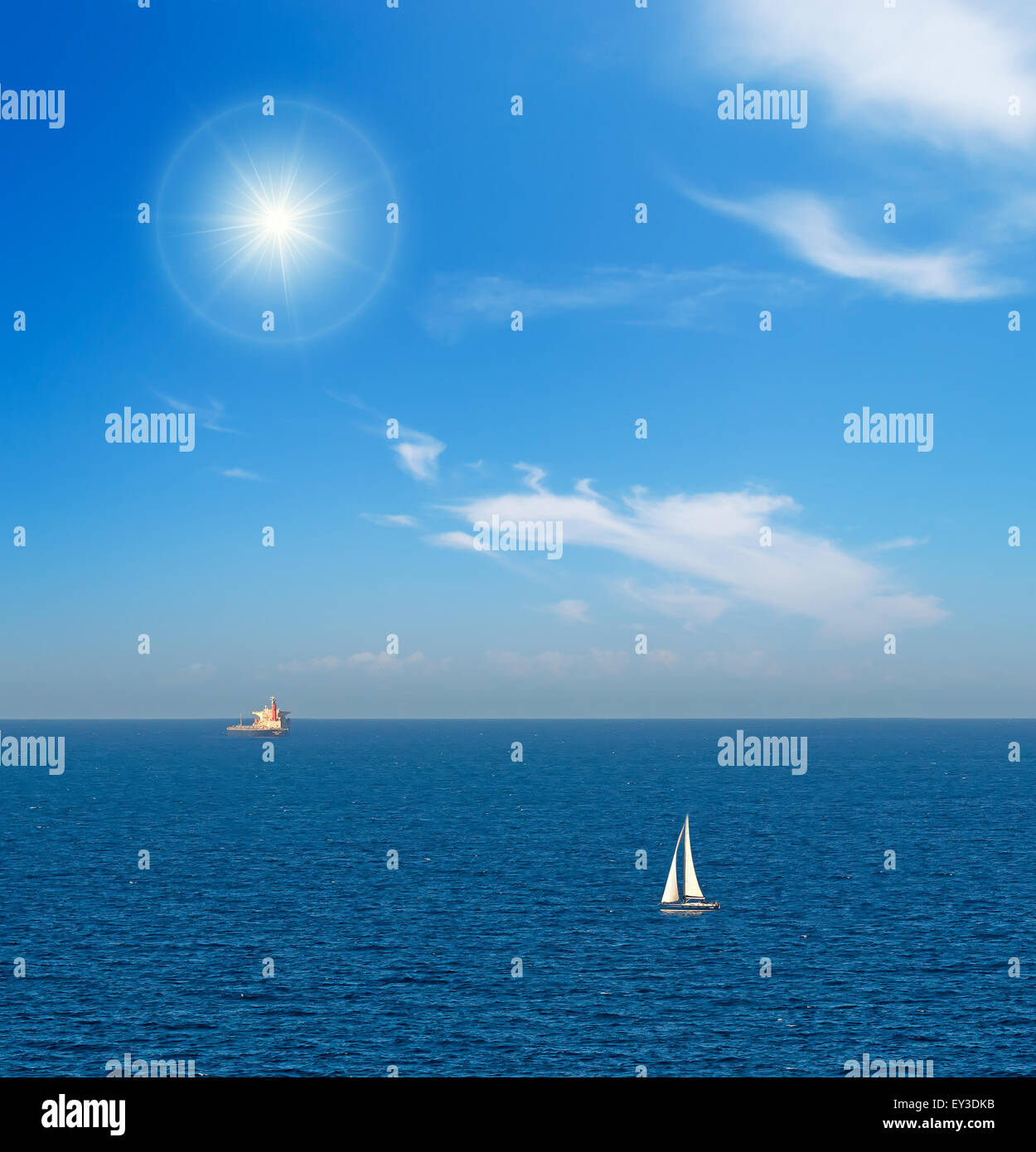 a white sailboat sailing in the blue sea Stock Photo - Alamy