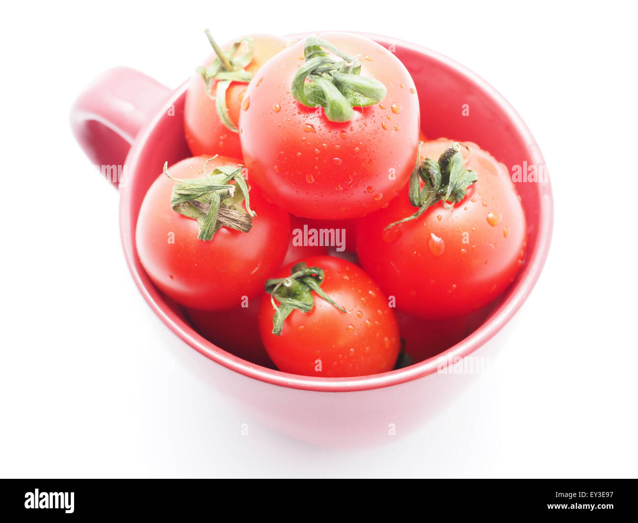 Tomatoes in a bowl on a white background Stock Photo
