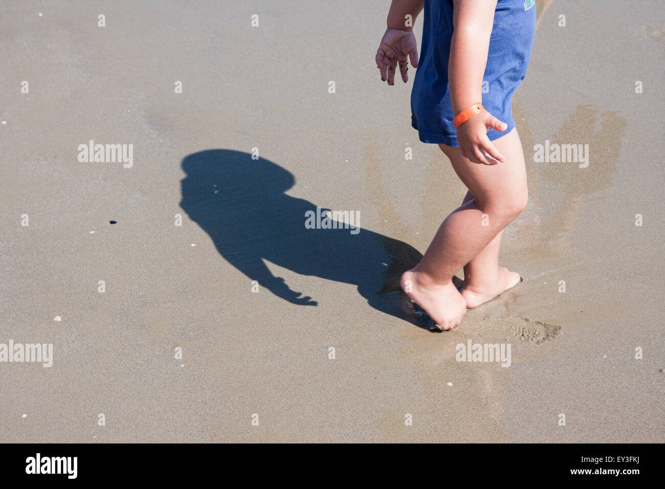 baby feet walking on sand beach Cesenatico Italy Stock Photo