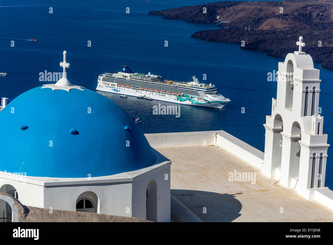 Santorini blue dome and bell tower above Sea Firostefani Santorini, Greek Island Greece Islands and moored Cruise ship Stock Photo