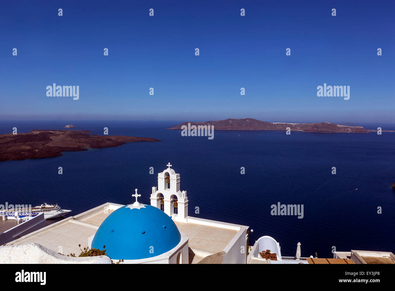 Santorini caldera, Edge Volcano Wall, Blue dome and bell tower, Famous Agioi Theodori church in Firostefani , Cyclades Islands, Aegean Sea, Greece Stock Photo