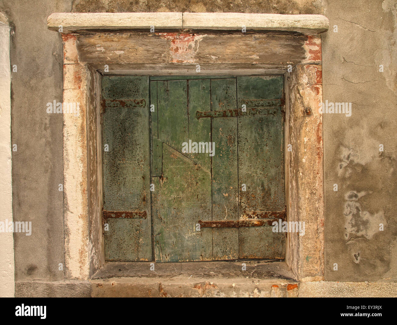 View of a closed old window with green shutters in a old building. Venice. Italy. Stock Photo