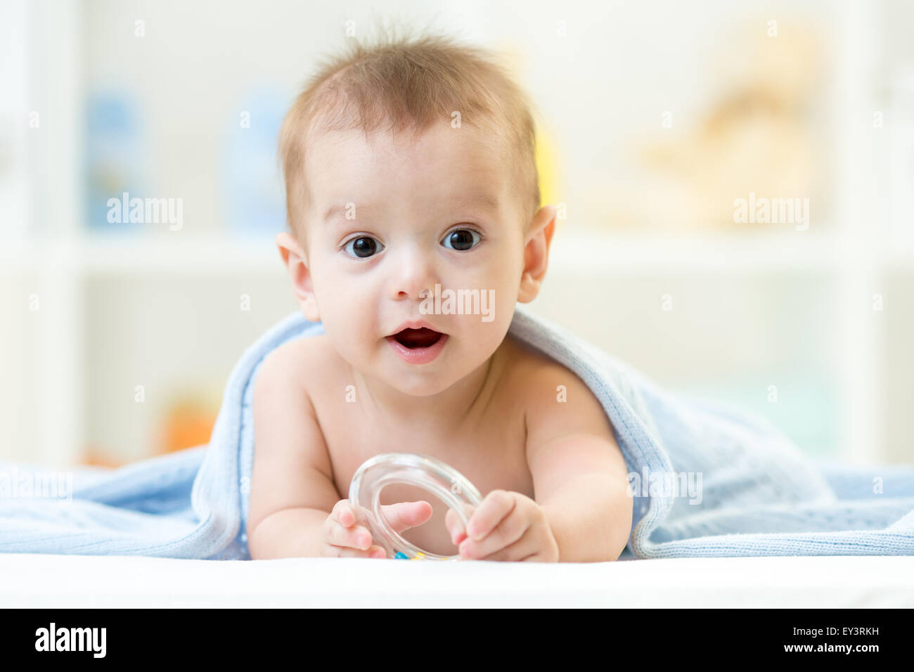 baby with teether wrapped blanket indoor Stock Photo Alamy