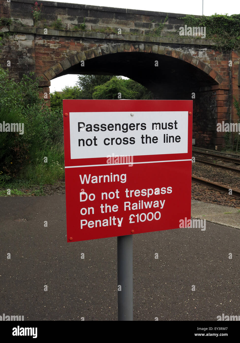 Passengers must not cross the line sign on railway platform, Station road, Annan, Dumfries, Scotland, UK Stock Photo