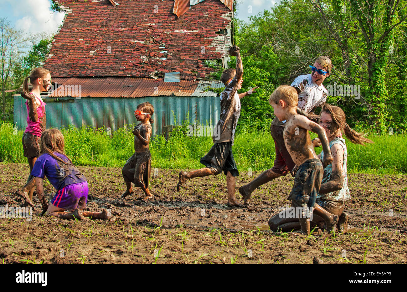 Kids playing mud fight Stock Photo