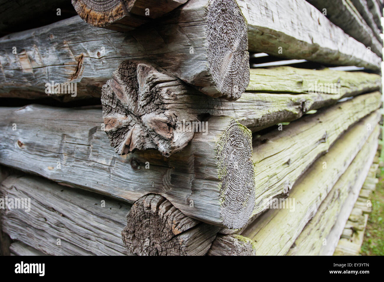 Close up of a log cabin with weathered wooden logs fitted closely together. Stock Photo