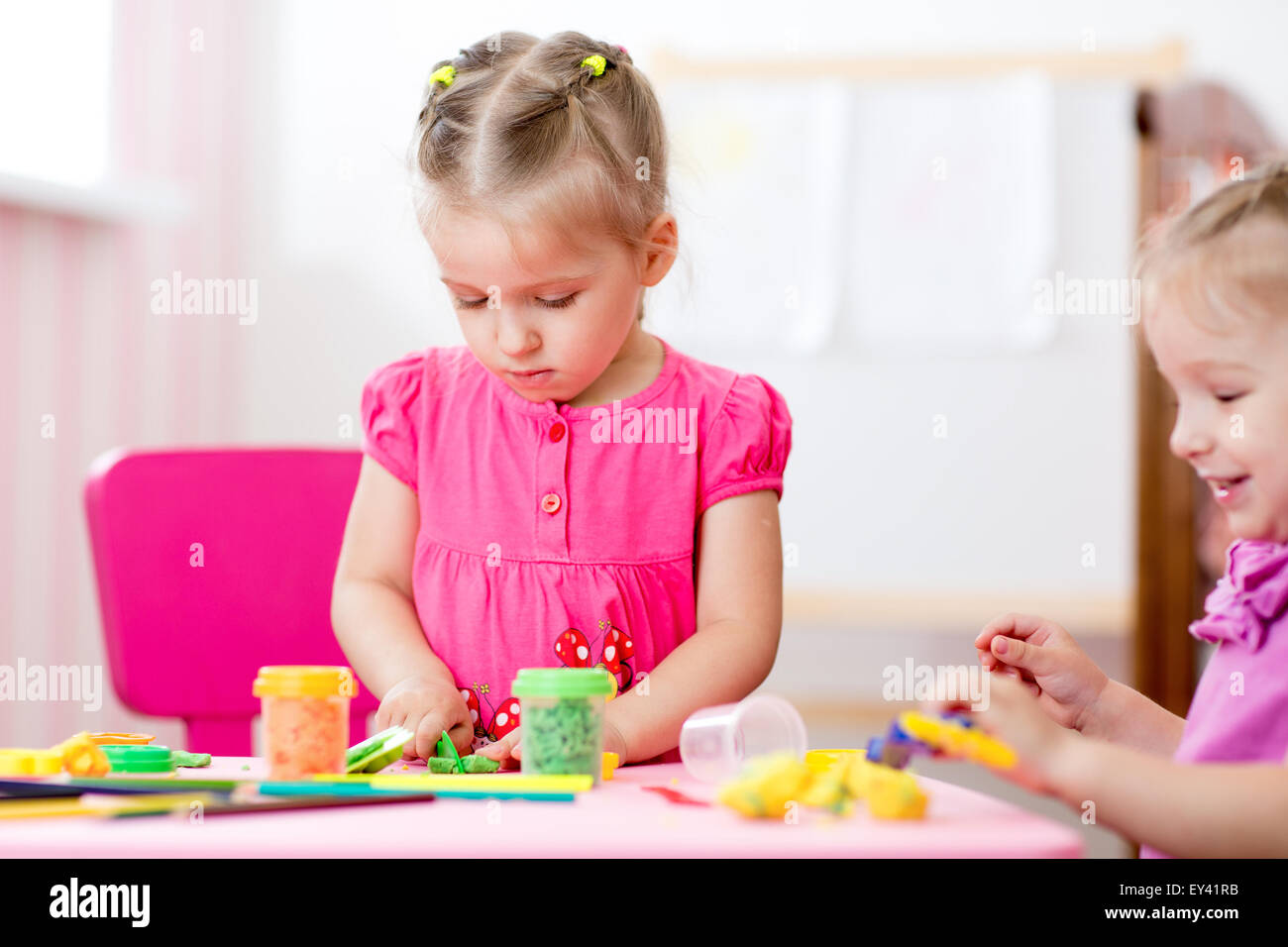 Children mould from clay in play room. Preschool. Stock Photo