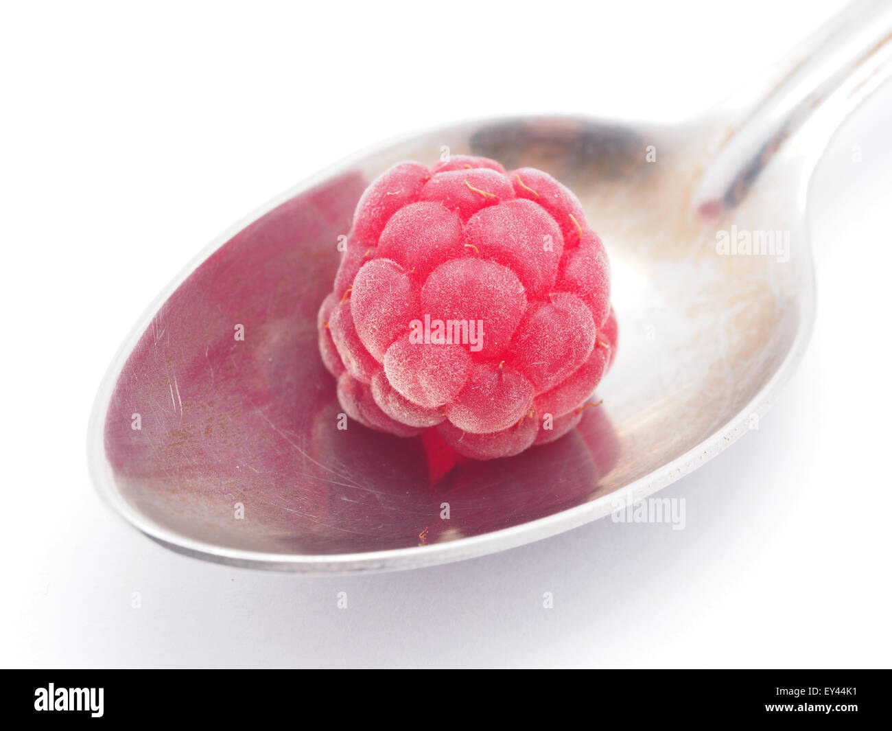 raspberries and spoon on a white background Stock Photo - Alamy