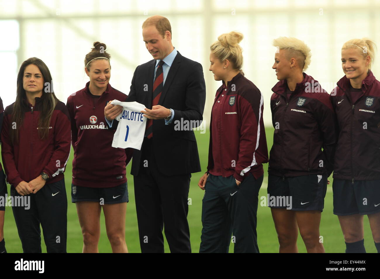 Prince William, Duke of Cambridge visits the England Senior Women’s football team at St George's Park National Football Centre ahead of their departure for the World Cup. A princess Charlotte football shirt is presented to the Duke.  Featuring: Prince Wil Stock Photo