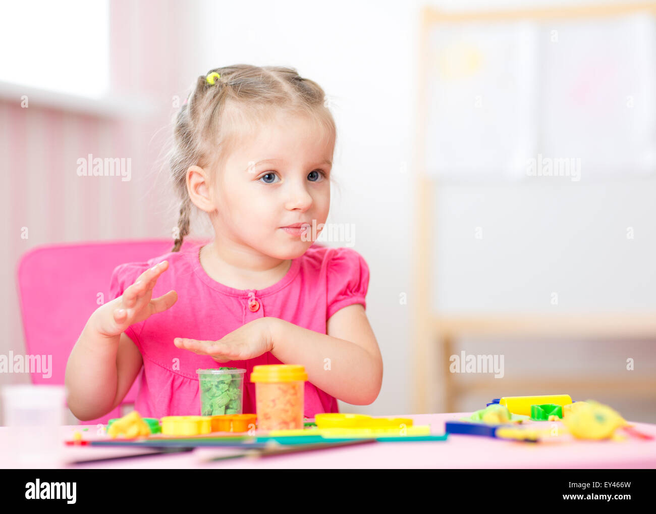 kid playing with play clay at home or  playschool Stock Photo
