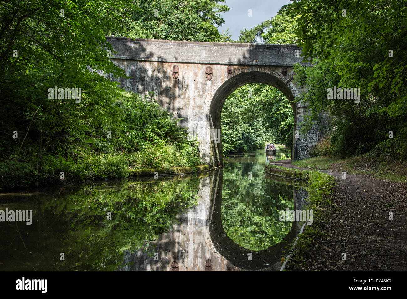 canal bridge with narrow boat barge, about to come through it in Shropshire union canal, Brewood Staffordshire 20th july 2015 uk Stock Photo