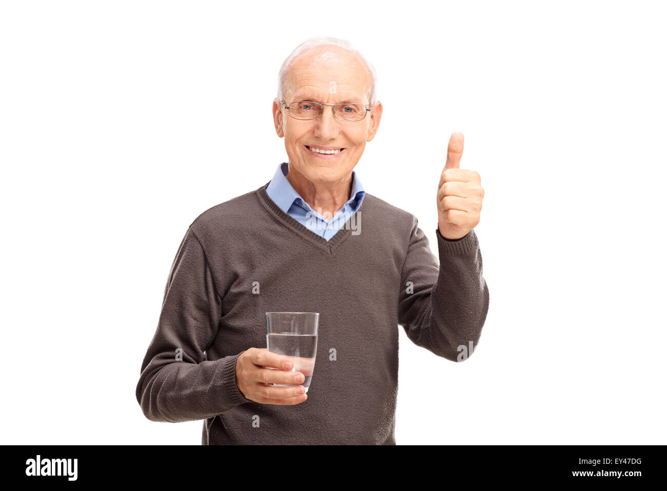 Studio shot of a senior man holding a glass of water and giving a thumb ...