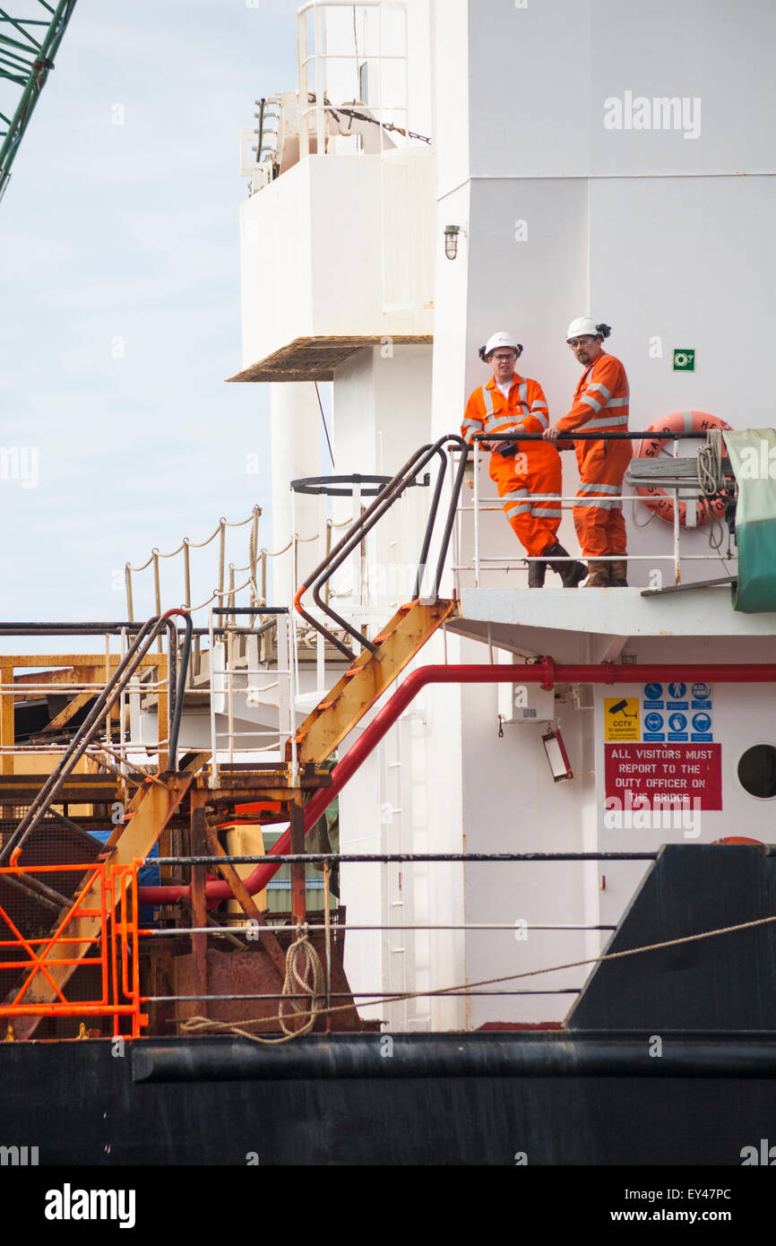 Workers in high visibility clothing on Sand Heron vessel at Poole Harbour in July Stock Photo