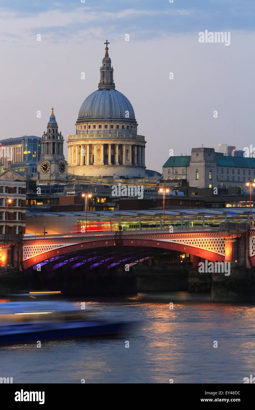 Blackfriars Railway Bridge, in front of St Paul's Cathedral, across the River Thames, at dusk, in London, UK Stock Photo