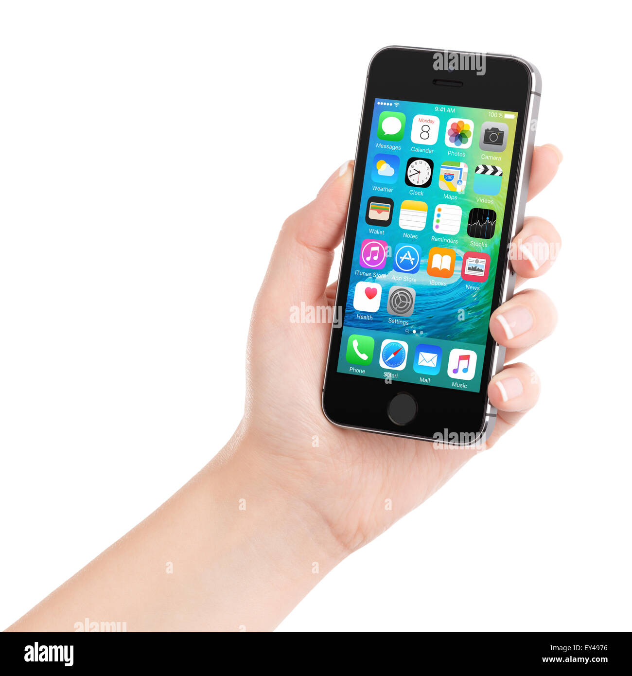 Female hand holding Apple Space Gray iPhone 5S displaying iOS 9 mobile operating system, designed by Apple and announced on WWDC Stock Photo