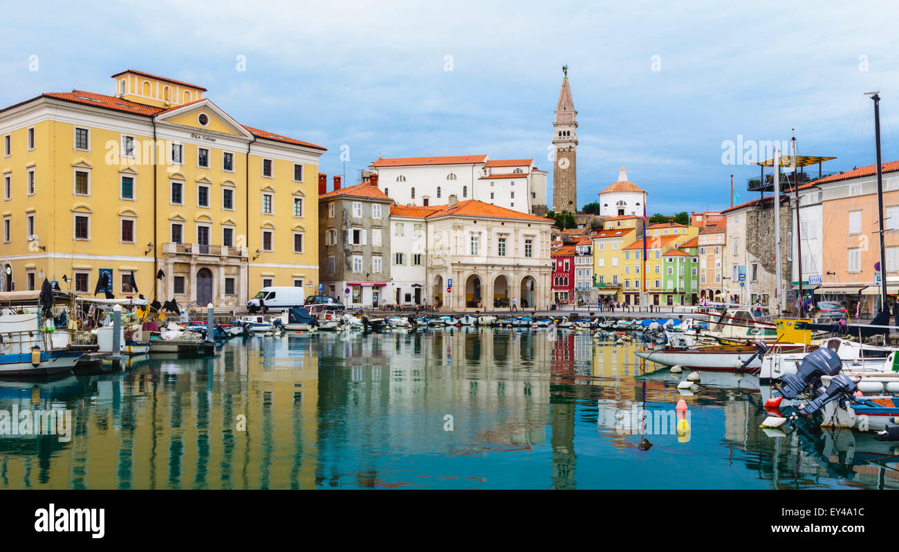 Piran, Primorska, Slovenia.  View across harbour to Tartinijev trg (or square) and the spire of St. George's cathedral. Stock Photo
